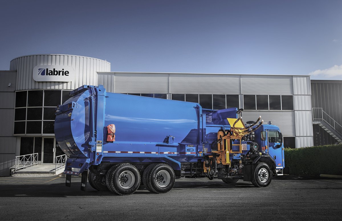 Labrie blue automated side loader in front of its headquarters.